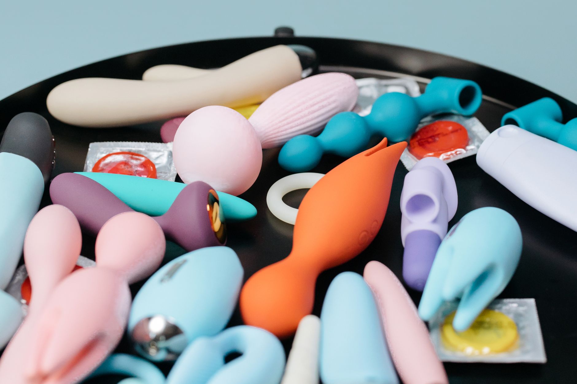 A teal suction vibrator on smooth white silk fabric
