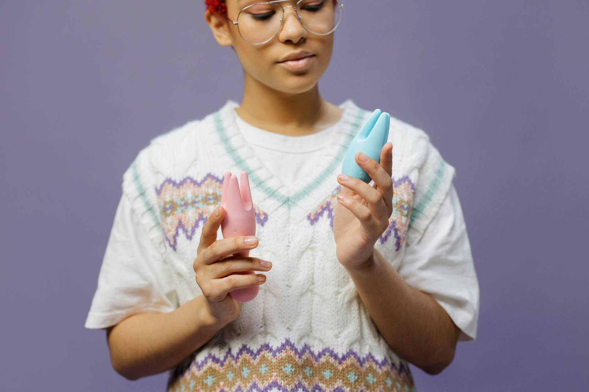 Woman holding lemon vibrators, considering pleasure after perimenopause